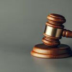 Judge gavel close up on paper background. Law and justice, legality concept